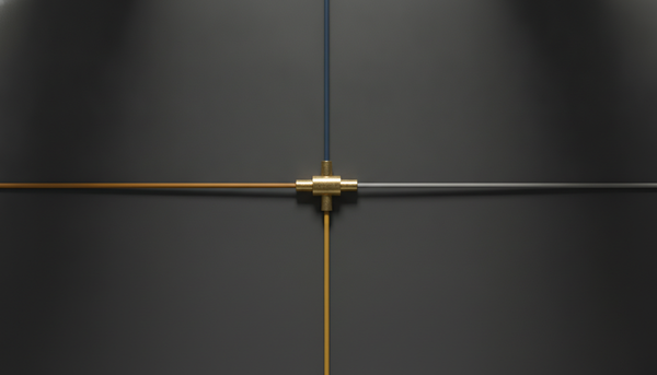 A brass three-port connector on a charcoal surface, with navy, amber and grey cables running out to the edges of the frame